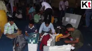 Polling officials checking the documents at an EVM distribution centre