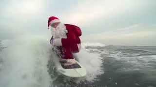 SATAN CALSE SURTFING ON OCEEN WIT GAPPY UKALEE IN BACKGROAND