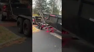 Maxx D roll off trailer pulling 14 yard dumpster