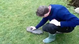 Smoothing a carved stone ball
