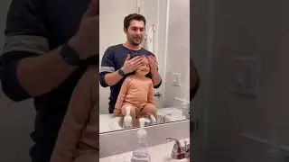 Dad is sharing a sweet moment with his daughter while doing her hair!