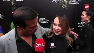 على البساط الأحمر لمهرجان الفيلم في مراكش.. ماجدولين الادريسي وعزيز داداس يتحدثان عن علاقتهما القوية
