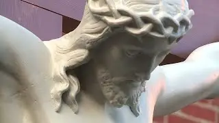 Historic crucifix repaired, back in place outside Maine Cathedral