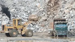 Caterpillar 966E Doing Hard Work of Rock Loading: Power and Precision of Big Wheel Loader