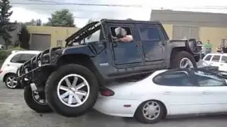 Hummer H1 open top stuck on a ford taurus