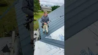 Roofing crew installing Textured Sea Slate Legacy Rib Metal on beautiful home. #Roofing