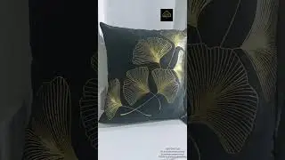 Stylish black and white throw pillows accented with golden, floral-inspired motifs. #interiordesign