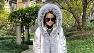 Luxury mink fur coat with hood and silver fox trim.