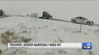 Close call: Truck sliding on ice nearly strikes two on the side of the road