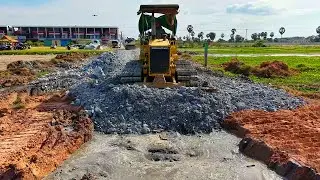 2Video delete canal to build new road by power dozer D31 pour stone with dump truck nearby complete