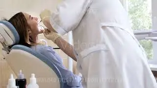 The doctor, the dentist checks the teeth of a young girl patient