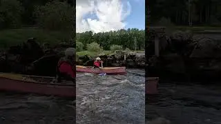 Canoe paddler passing through gate