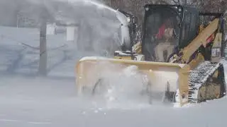 Skid steer mounted blower clears the way