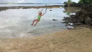 Little Girl Slips Off Rope Swing and Falls on Shallow Side of Water - 1383551