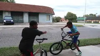 2 kids arguing about bicycle