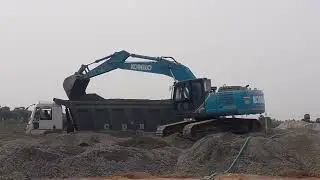 JCB working in gravel stone .... loading tipper and truck