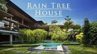 Tropical garden house with a water reservoir surrounded by many trees. Guz Architects