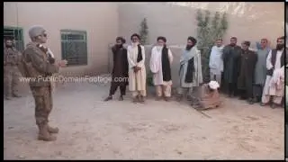 War in Afghanistan - U.S. Military Translator talking to Afghan men archival stock footage