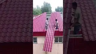 Efficient Roofing Installing Metal Panels on a House