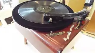 Vintage transcription type 2 speed manual record player playing a 78 RPM record.