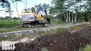 Volvo Excavator dredging the shallow ditch