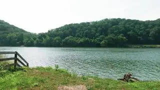 Drone Footage Of A River Surrounded By Lush Land