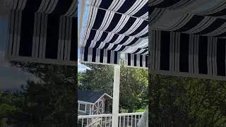 Beautiful striped fabric retractable canopies over backyard deck