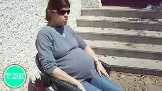 Baby strokes the huge belly of a girl pregnant with twins