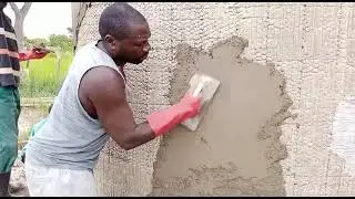 Rainwater Catchment Tank applying mortar to tank walls in Kabwe, Zambia.