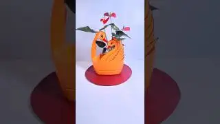 A beautiful swan-shaped flower pot made from an empty laundry detergent bottle