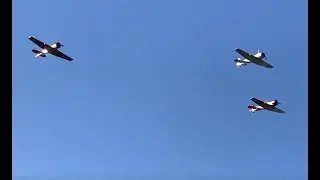 T-6 Texan trainer aircraft fly over the Battleship New Jersey