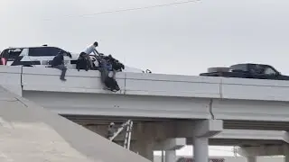 Deputy left dangling from overpass after semi rams into cruiser