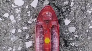 A cargo ship is going through the frozen sea. Russia.