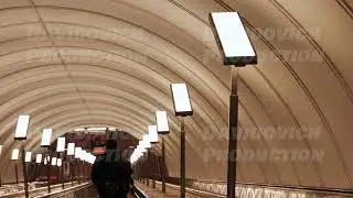 Passenger walking in illuminated corridor of Moscow Metro