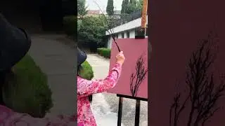 a person is making a creative picture from twigs and colors