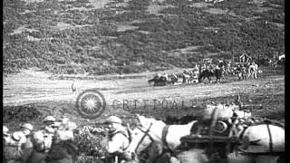 French soldiers advance along with supplies loaded on carts and horses crossing m...HD Stock Footage