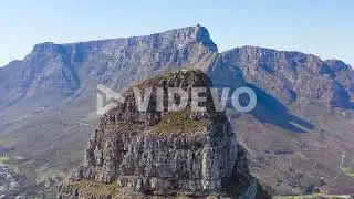 Amazing aerial shot over the top of Lion's Head peak with Table Mountain background in Cape Town Sou