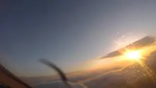 Flying above the clouds in sunset - Piper Archer