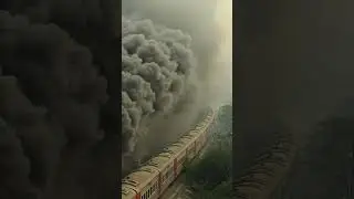 Diesel train with thick black smoke rising, dramatic and cinematic atmosphere