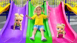 Алиса и кукла играют на открытой детской площадке