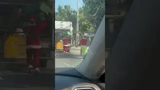 Santiago's garbage collectors bring Christmas cheer in Santa and Grinch attire