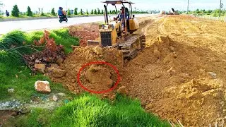 Interesting activities old dozer pushing dirt filling land on base boundary along the high way road