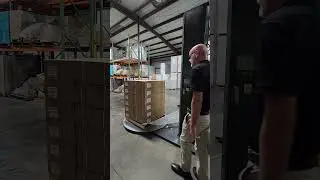 Wrapping a Dark Pallet with White Opaque Stretch Wrap.