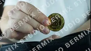 Stock footage. Man putting a bitcoin coin into his wallet.