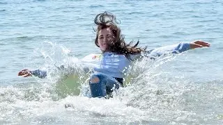 COOL! A MODEL WET HER CLOTHES IN THE SEA AND AFTER POSE IN THEM ON THE WILD COAST FOR WETLOOK VIDEO