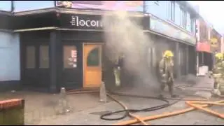 Firefighters enter The Locomotive in Burton as smoke billows out into the street