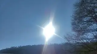 Blue sky behind the shining waves of the sun 