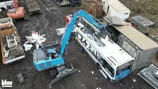 Fuchs 320F with a selecting grab Arden S1402 dismantling a bus
