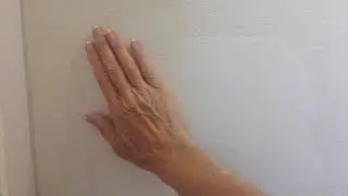 Repairing the wall after removing the large bathroom mirror.