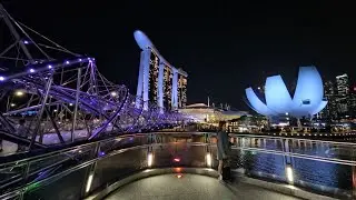 The Helix Bridge at night with Singapore City's best landmarks - Marina Bay Sands, ArtScience Museum